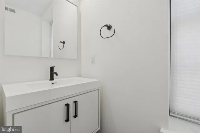 a bathroom with a sink and mirror