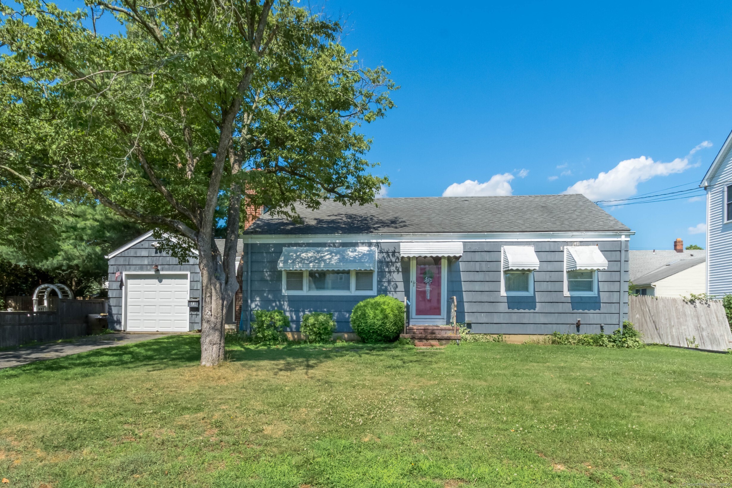 a front view of house with yard and green space