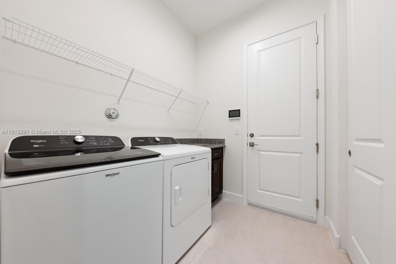 5786 Aleppo Pne Place Westlake, FL 33470 - Photo 27 of 30 a utility room with dryer and washer