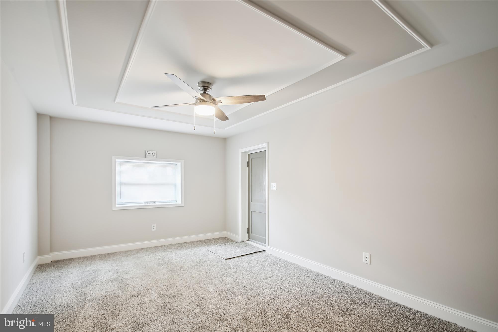 106 Charles Road Linthicum Heights, MD 21090 - Photo 27 of 44 an empty room with a chandelier fan and windows