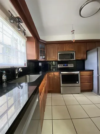 a kitchen with a sink and a stove top oven
