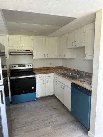 a kitchen with stainless steel appliances granite countertop a stove and a refrigerator