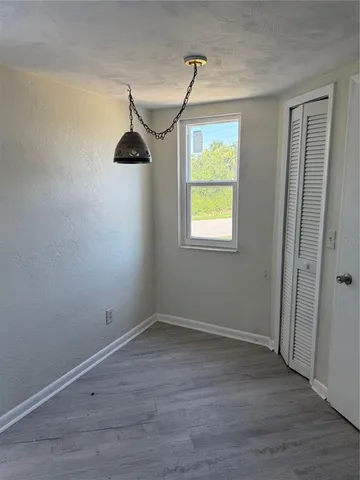 wooden floor in an empty room with a mirror