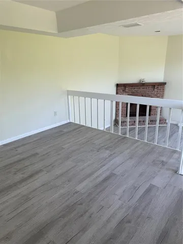 a view of wooden floor and staircase in a room
