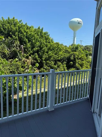 a view of a small space with wooden floor and a window
