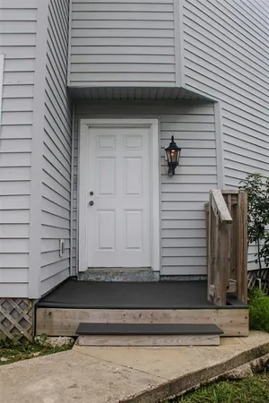 a view of front door and deck of the house