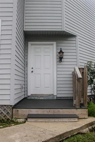 a view of front door and deck of the house