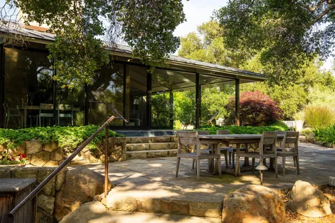 a backyard of a house with yard and outdoor seating