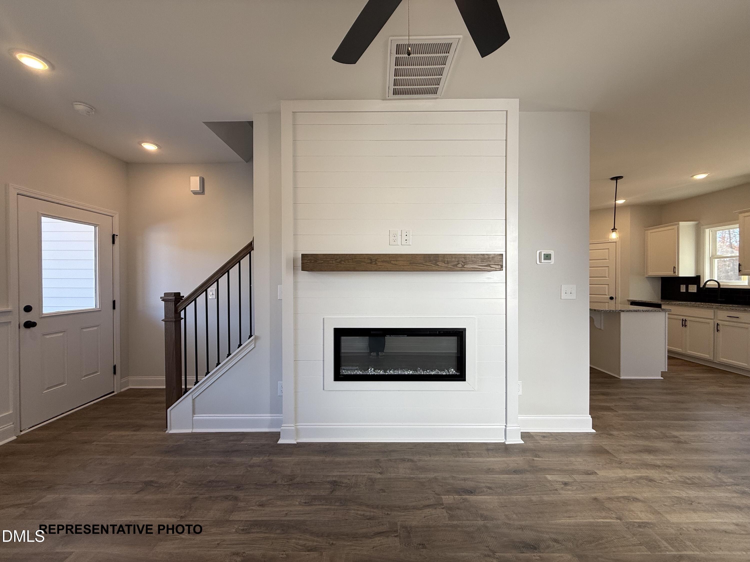 308 Bluejay Street Clayton, NC 27520 - Photo 3 of 14 a view of an empty room wooden floor and a kitchen