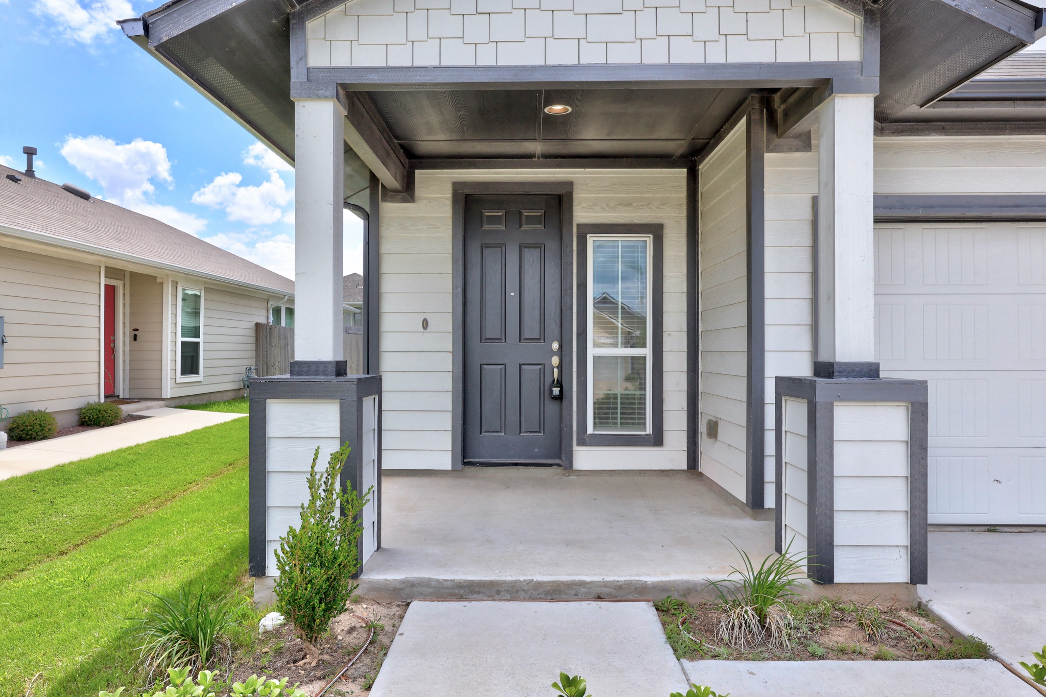 213 Graver Street Georgetown, TX 78626 - Photo 2 of 33 A welcoming front entry with modern siding and clean lines offers inviting curb appeal.