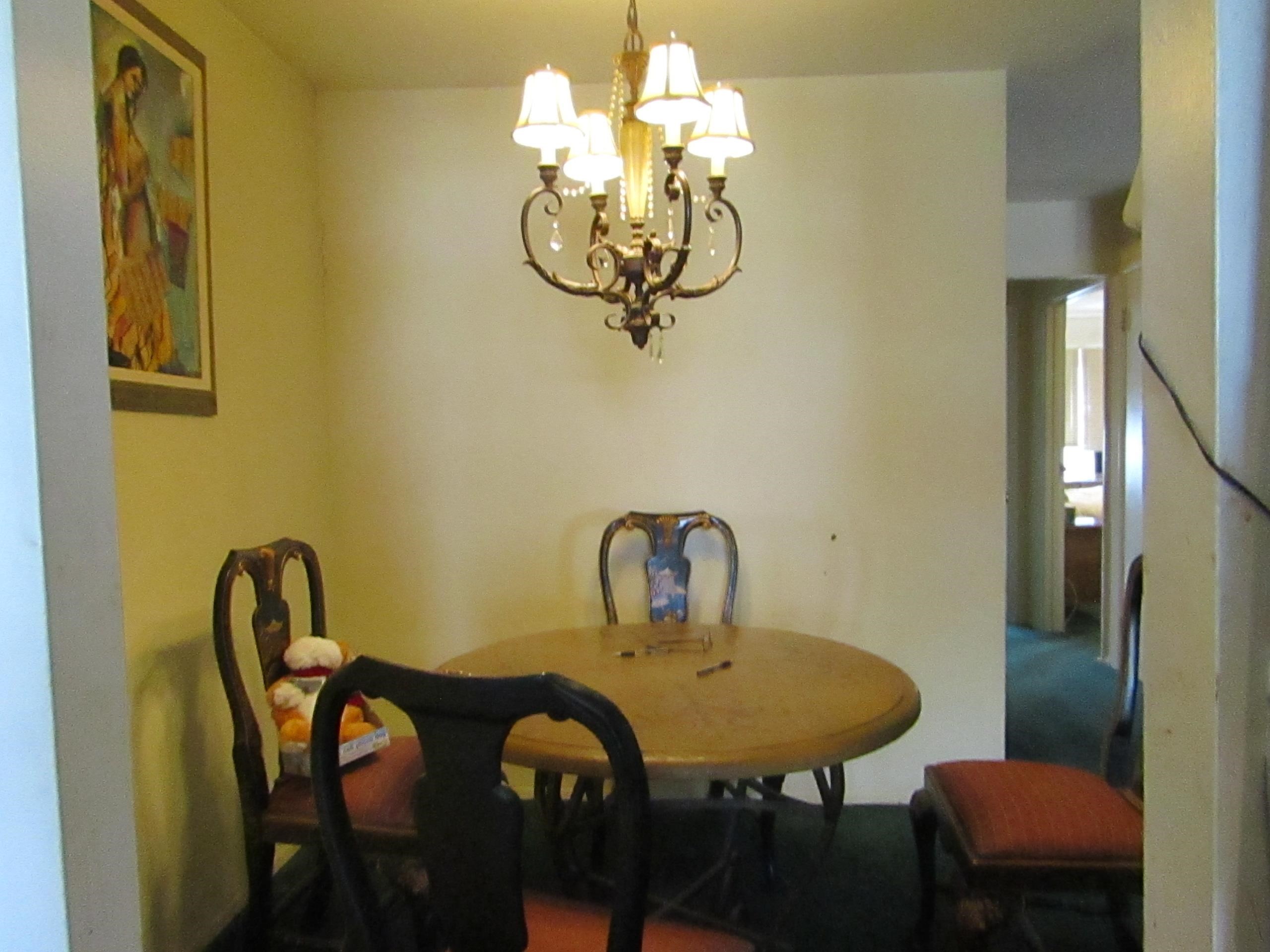31 Exeter Road Jersey City, NJ 07305 - Photo 14 of 39 a dining room with a table chairs and chandelier