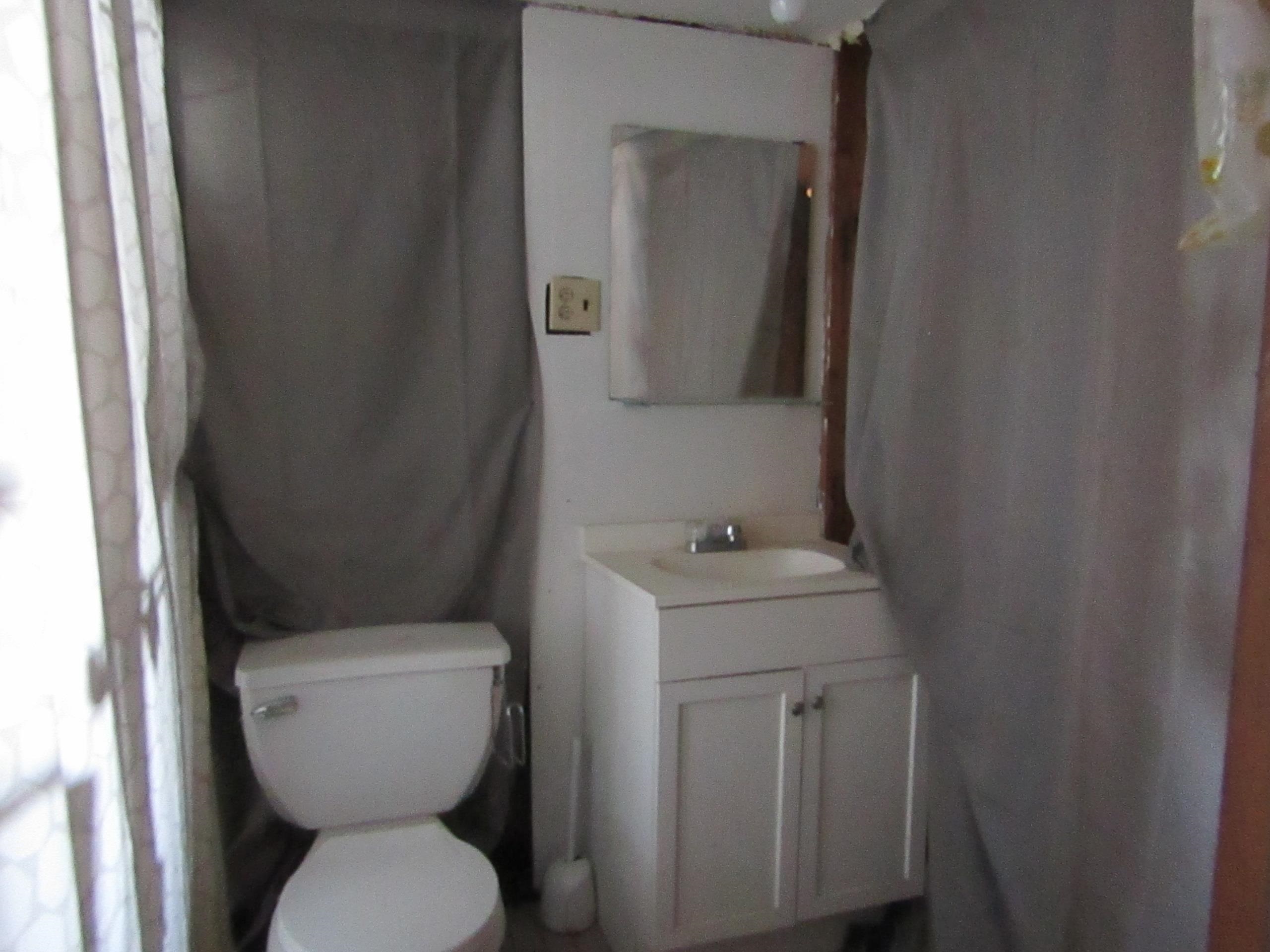 31 Exeter Road Jersey City, NJ 07305 - Photo 26 of 39 a bathroom with a toilet sink and mirror