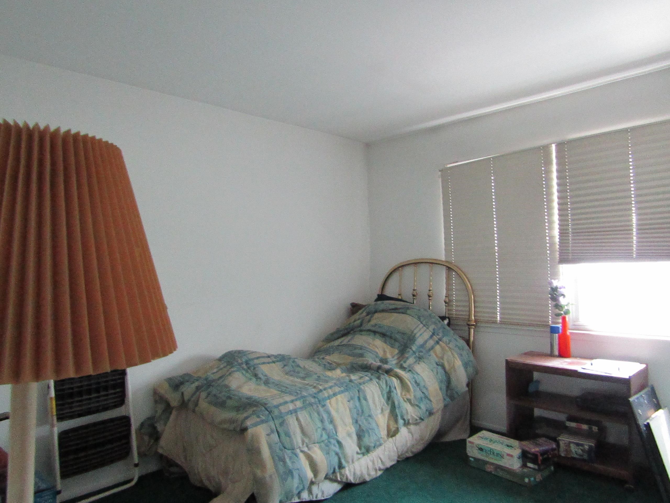 31 Exeter Road Jersey City, NJ 07305 - Photo 4 of 39 a bedroom with a bed and a window