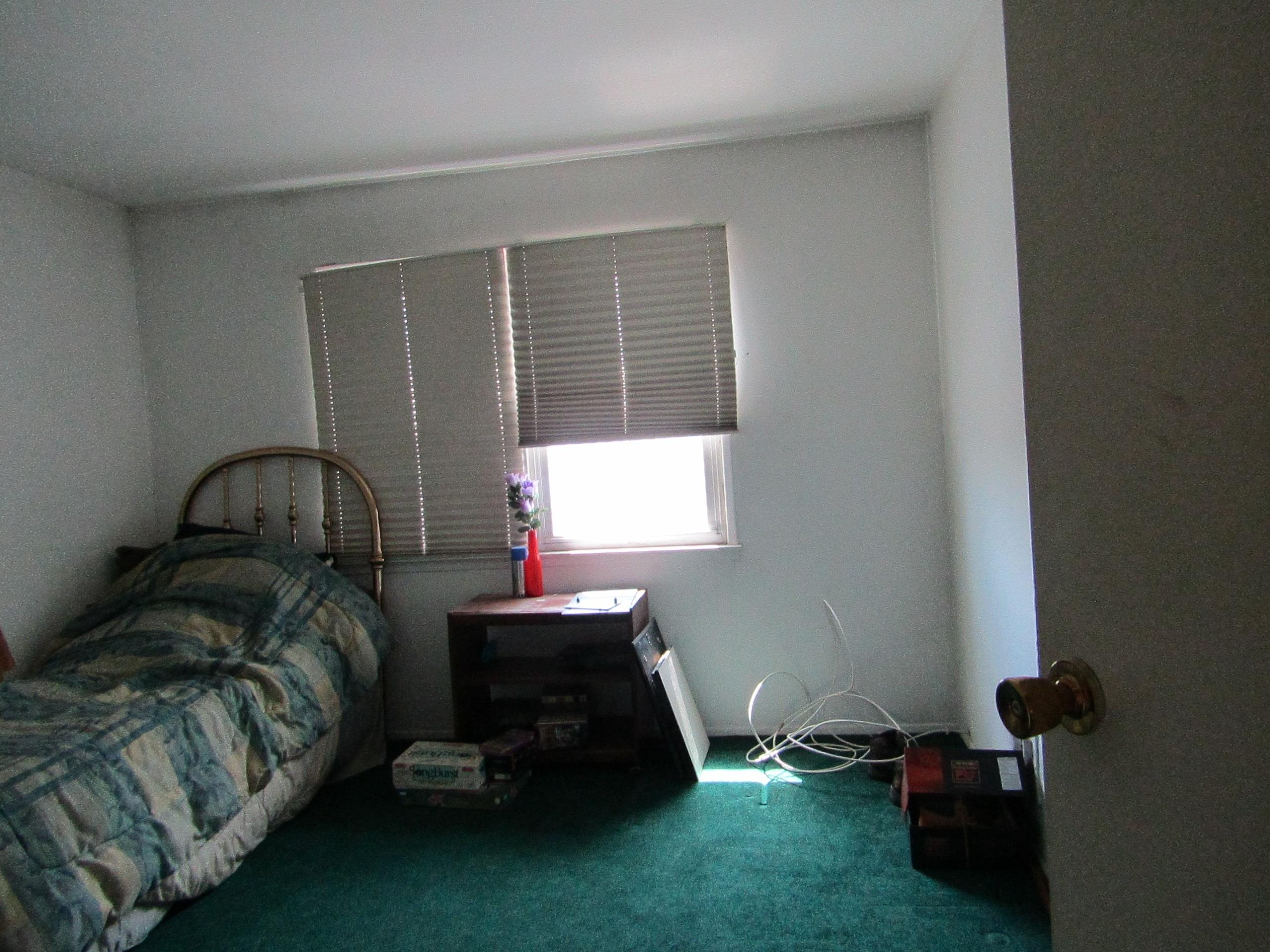 31 Exeter Road Jersey City, NJ 07305 - Photo 5 of 39 a bedroom with a bed and a window