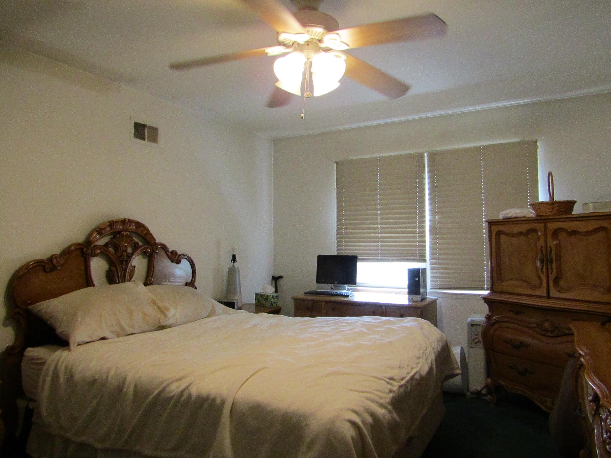 31 Exeter Road Jersey City, NJ 07305 - Photo 6 of 39 a bedroom with a bed and a chandelier