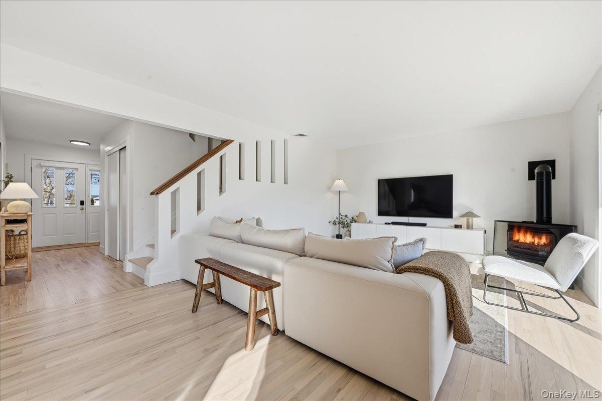 141 Annuskemunnica Road Babylon, NY 11702 - Photo 12 of 44 a living room with furniture and a flat screen tv