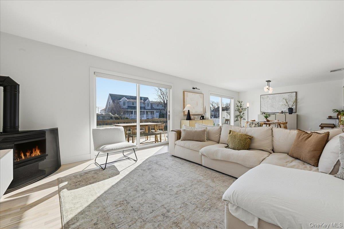 141 Annuskemunnica Road Babylon, NY 11702 - Photo 13 of 44 a living room with furniture and a fireplace