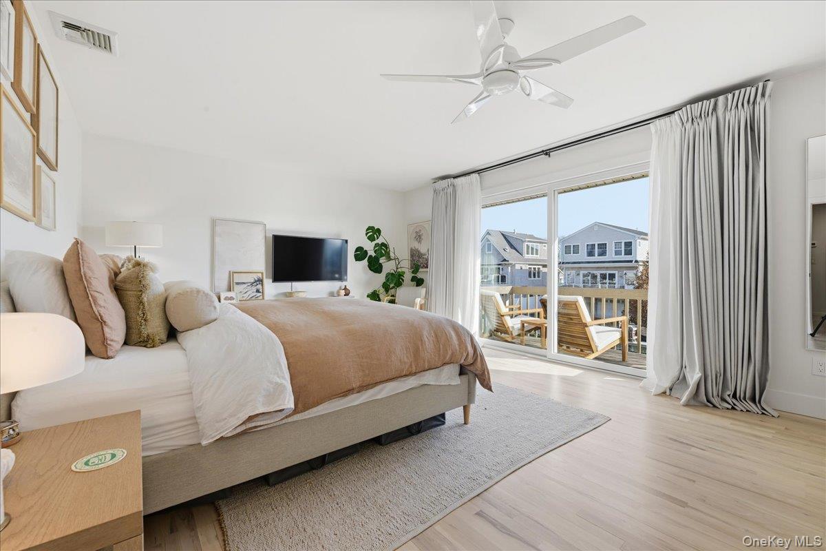 141 Annuskemunnica Road Babylon, NY 11702 - Photo 19 of 44 a bedroom with a large bed and a tv