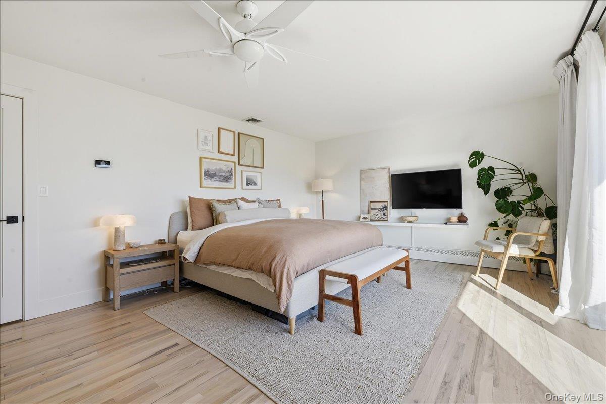 141 Annuskemunnica Road Babylon, NY 11702 - Photo 20 of 44 a bedroom with a bed and a flat screen tv