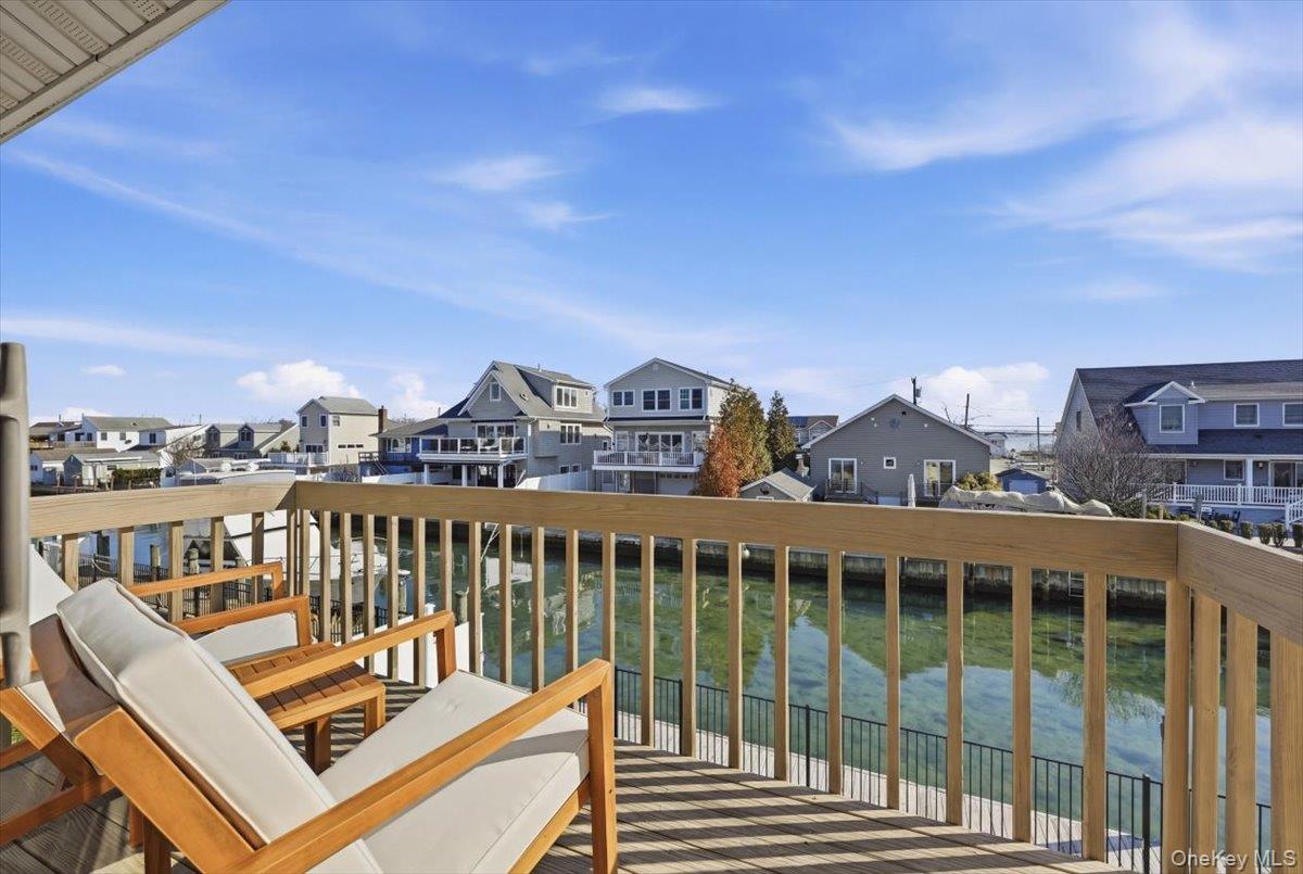 141 Annuskemunnica Road Babylon, NY 11702 - Photo 22 of 44 a view of a balcony with two chairs and a table