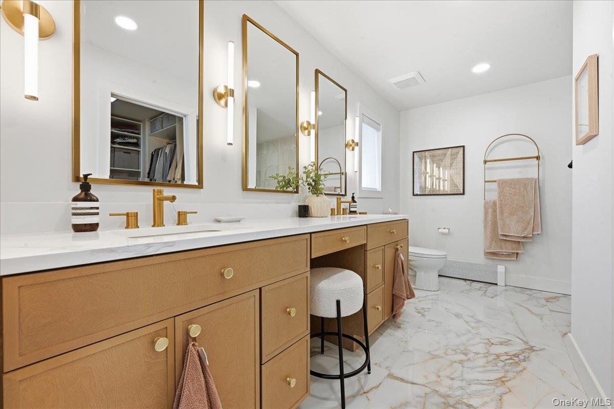 141 Annuskemunnica Road Babylon, NY 11702 - Photo 24 of 44 a bathroom with a sink mirror and toilet