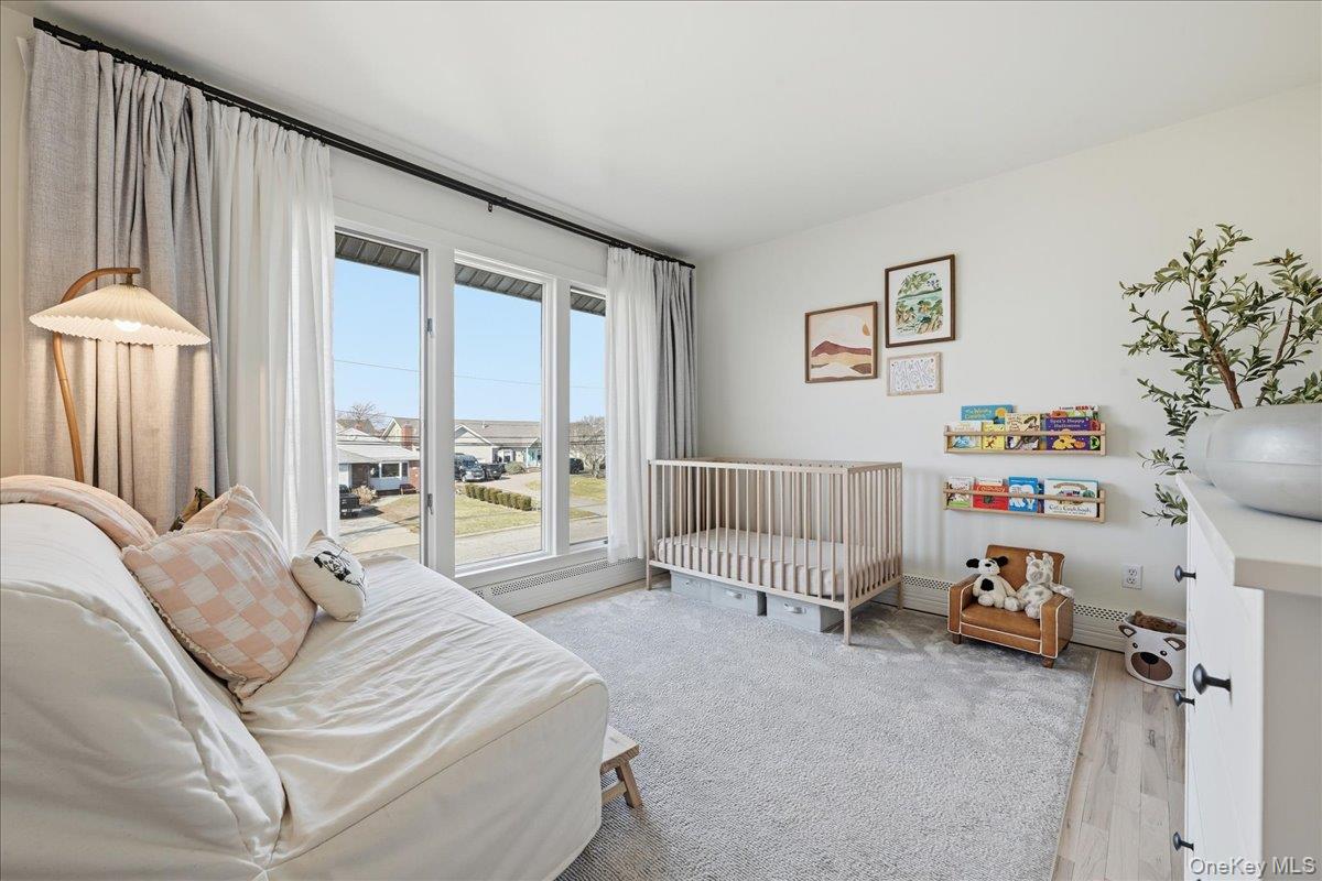 141 Annuskemunnica Road Babylon, NY 11702 - Photo 28 of 44 a bedroom with furniture and a large window