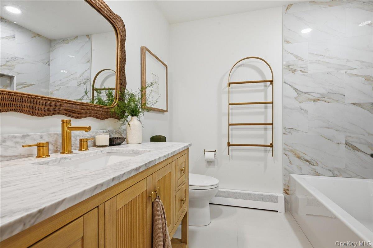 141 Annuskemunnica Road Babylon, NY 11702 - Photo 30 of 44 a bathroom with a granite countertop sink vanity mirror bathtub shower and toilet