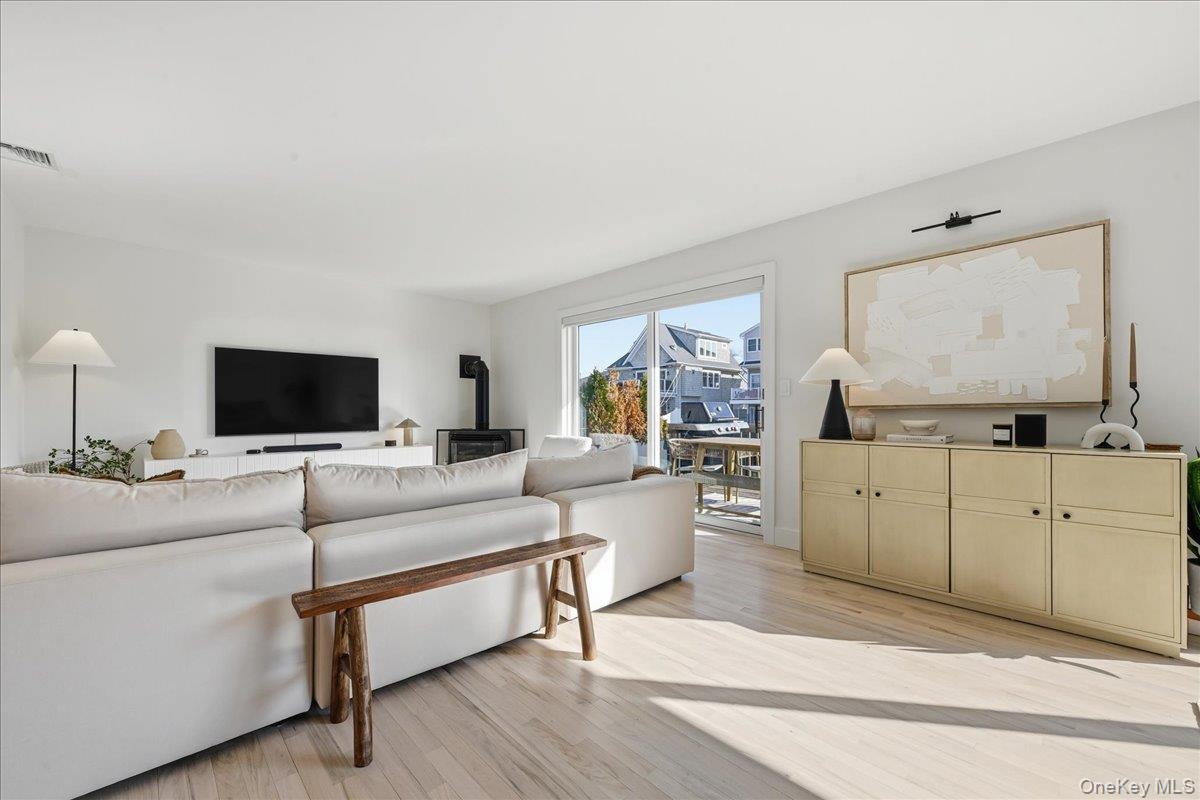 141 Annuskemunnica Road Babylon, NY 11702 - Photo 3 of 44 a living room with furniture and a flat screen tv