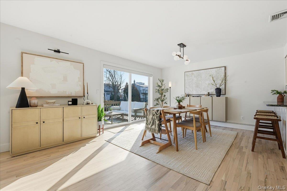 141 Annuskemunnica Road Babylon, NY 11702 - Photo 4 of 44 a view of a dining room with furniture and chandelier