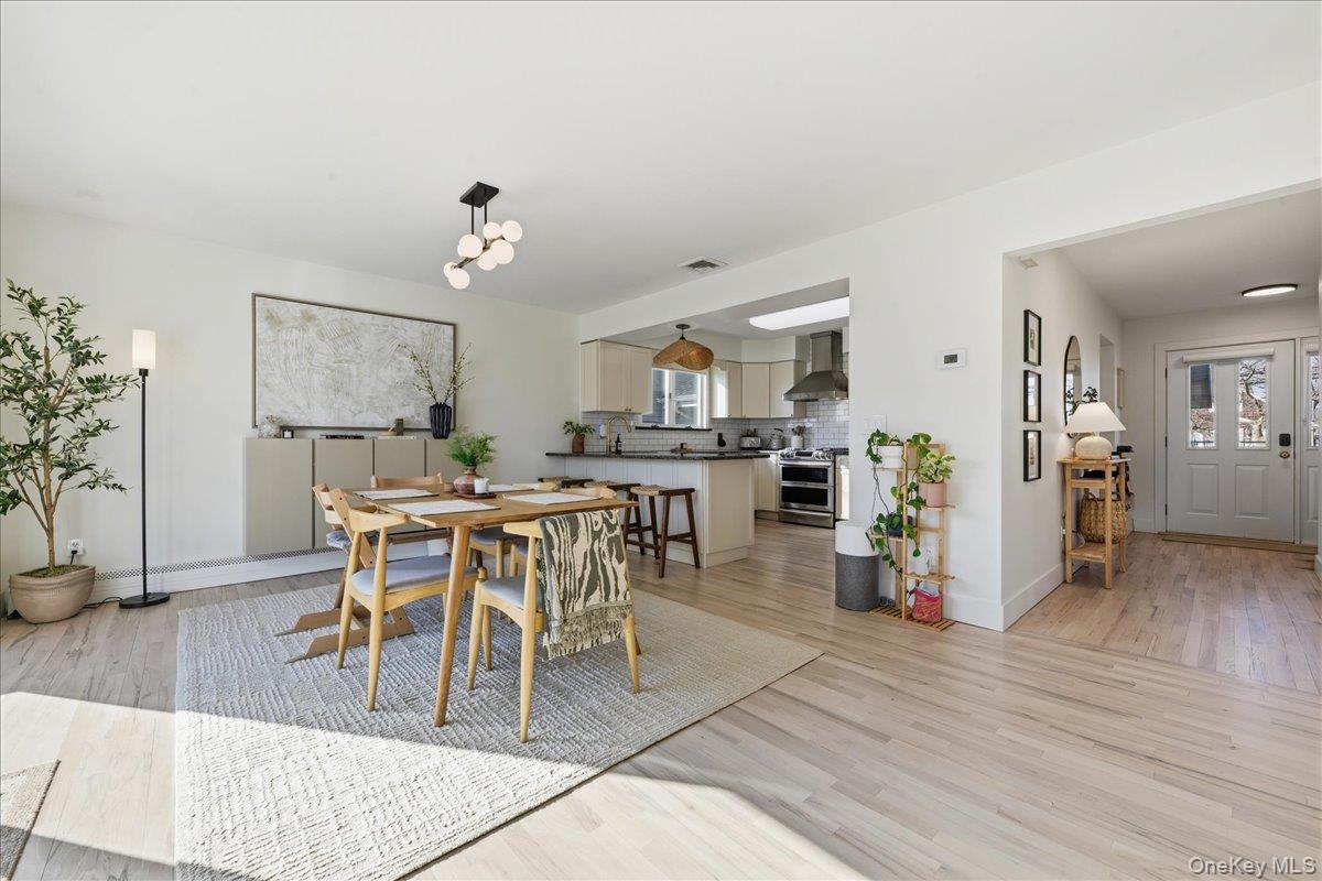 141 Annuskemunnica Road Babylon, NY 11702 - Photo 5 of 44 a view of a dining room with furniture and wooden floor