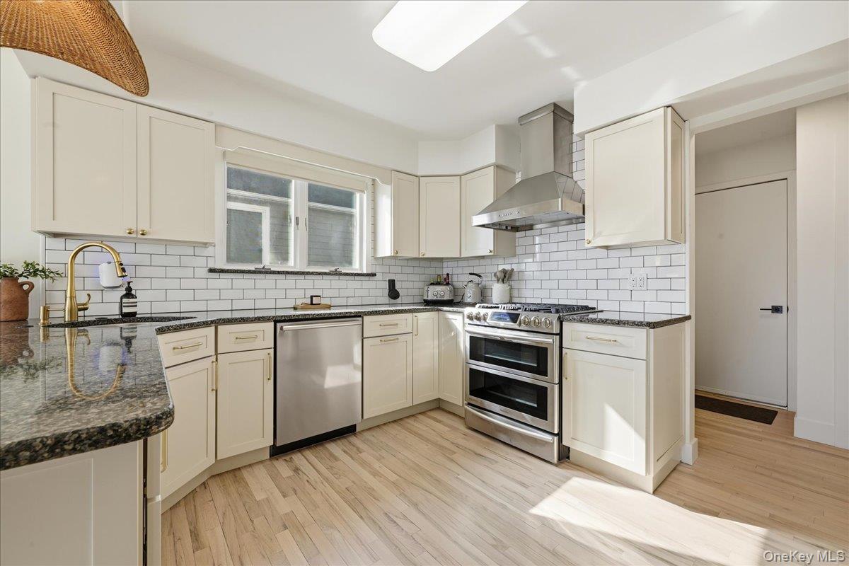 141 Annuskemunnica Road Babylon, NY 11702 - Photo 7 of 44 a kitchen with stainless steel appliances granite countertop a stove sink and cabinets