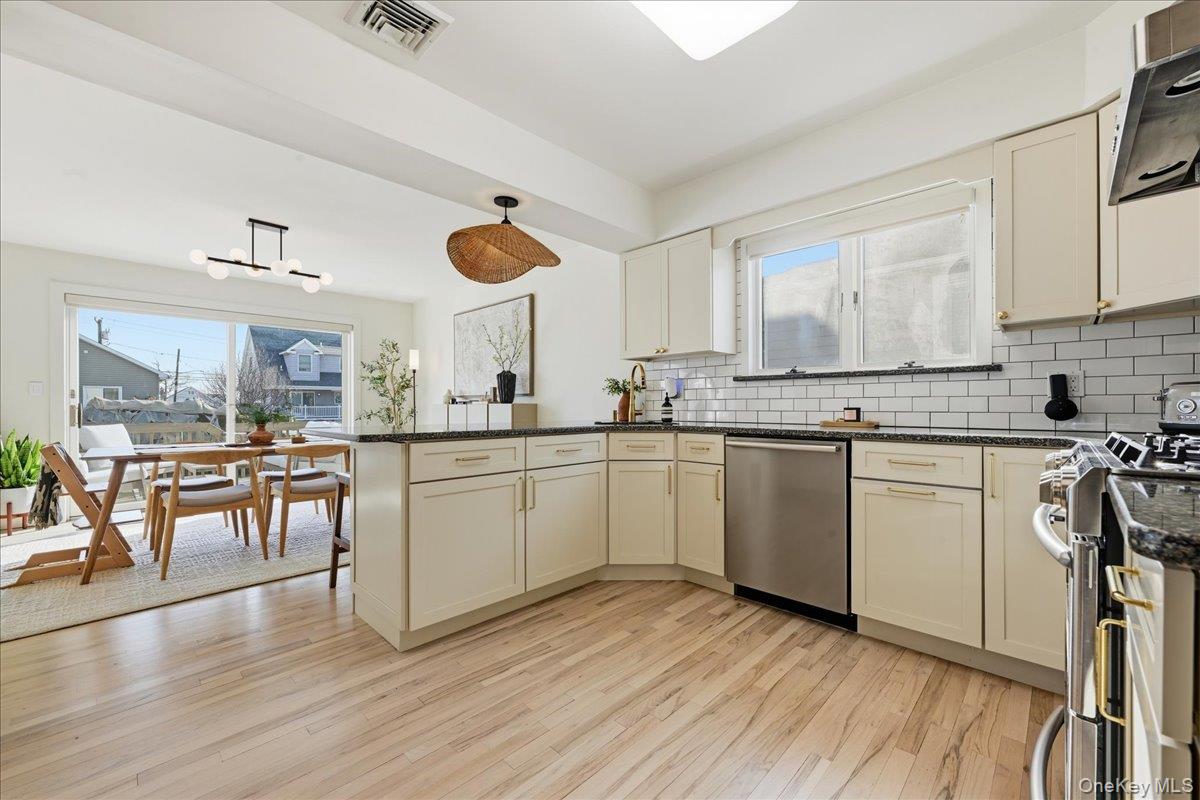 141 Annuskemunnica Road Babylon, NY 11702 - Photo 9 of 44 a kitchen with a sink appliances cabinets and wooden floor