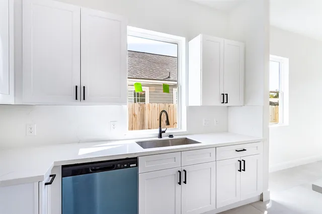 a kitchen with a sink and cabinets