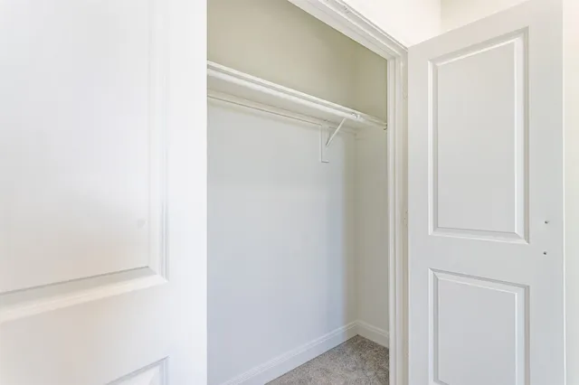 a close view of a closet with white cabinet