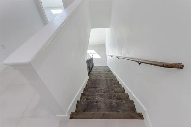 a white house that has tree in front of it