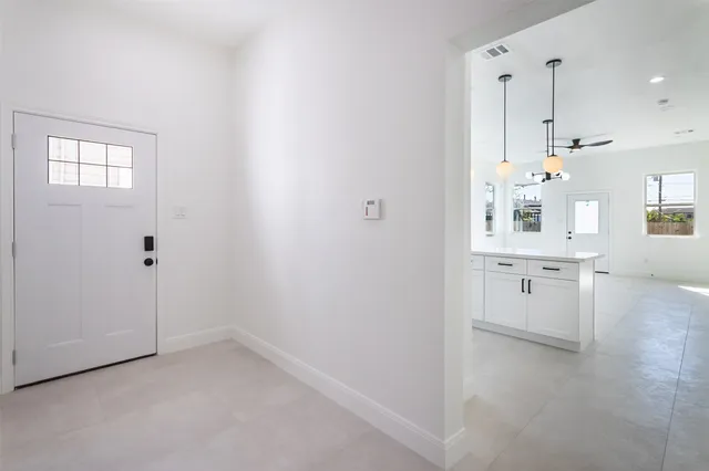 a view of a kitchen with white cabinets