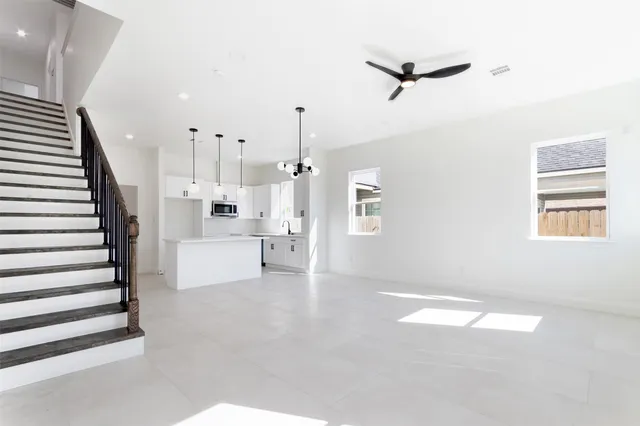 a view of a livingroom with a ceiling fan and window