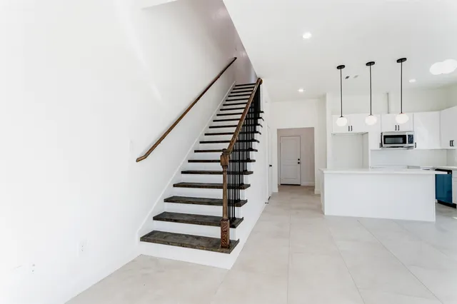 a view of a kitchen with furniture and staircase