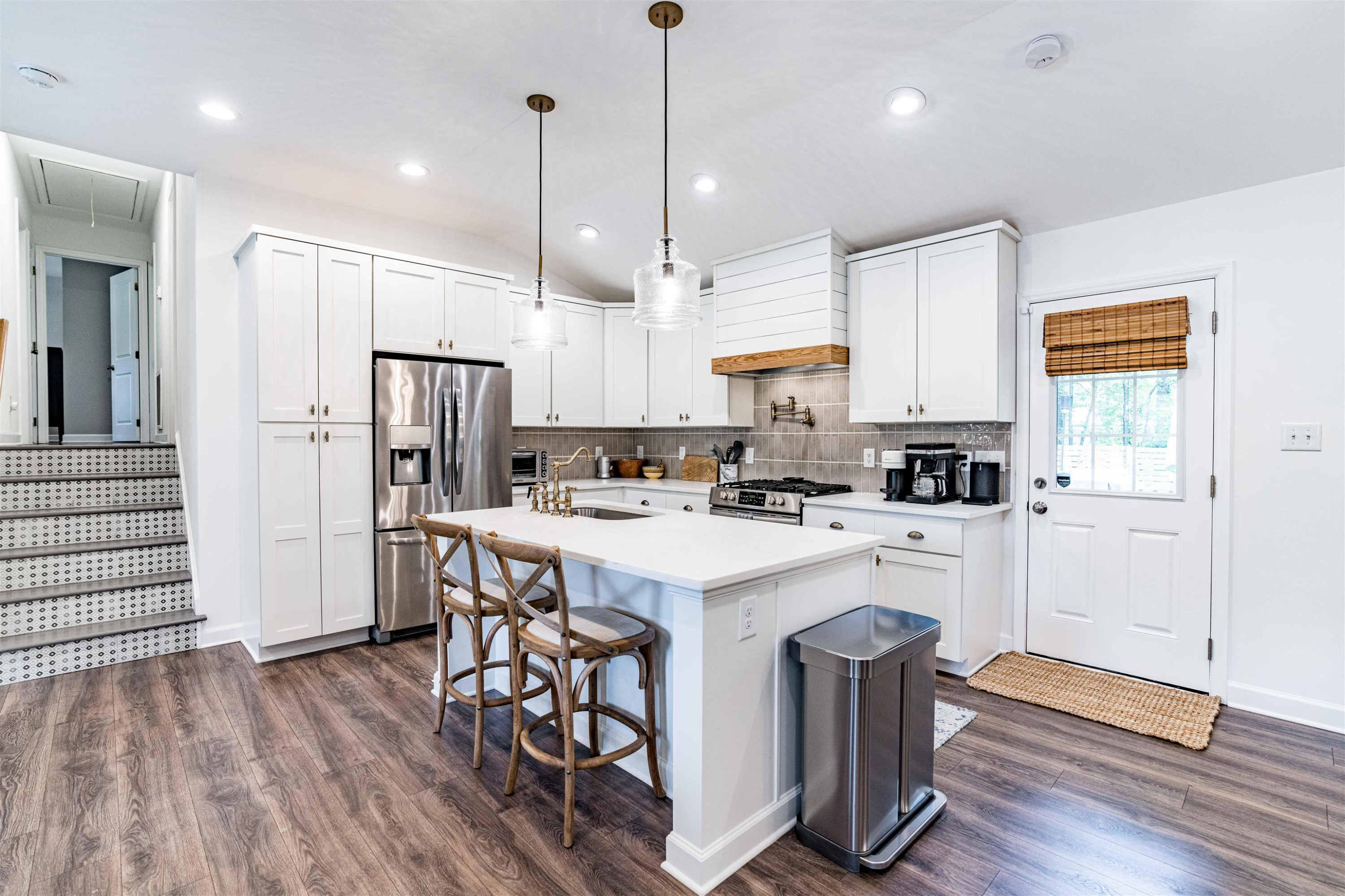 1505 Windbur Place Raleigh, NC 27609 - Photo 14 of 44 a kitchen with wooden floors a center island stainless steel appliances and cabinets