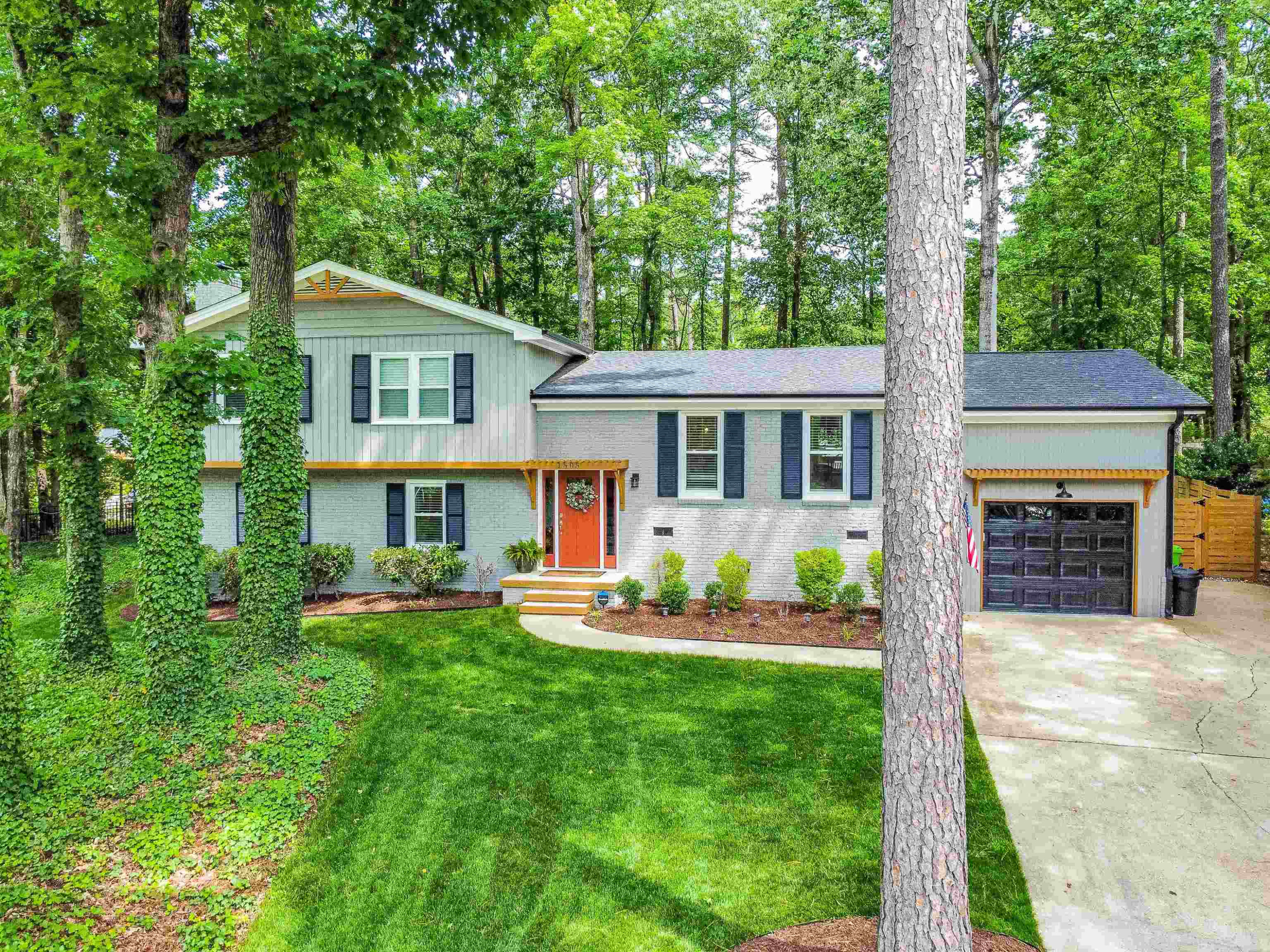 1505 Windbur Place Raleigh, NC 27609 - Photo 2 of 44 a front view of a house with a yard deck and patio
