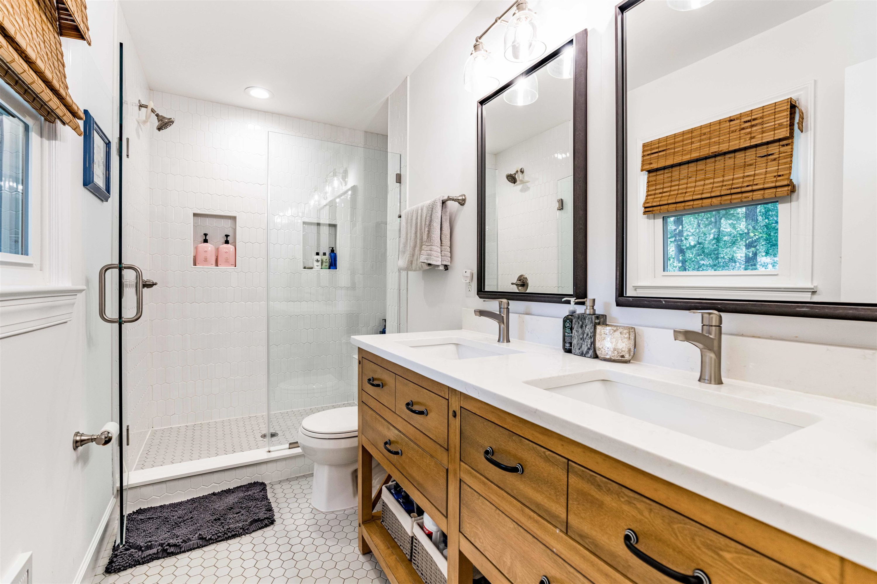 1505 Windbur Place Raleigh, NC 27609 - Photo 22 of 44 a bathroom with a granite countertop sink toilet and shower