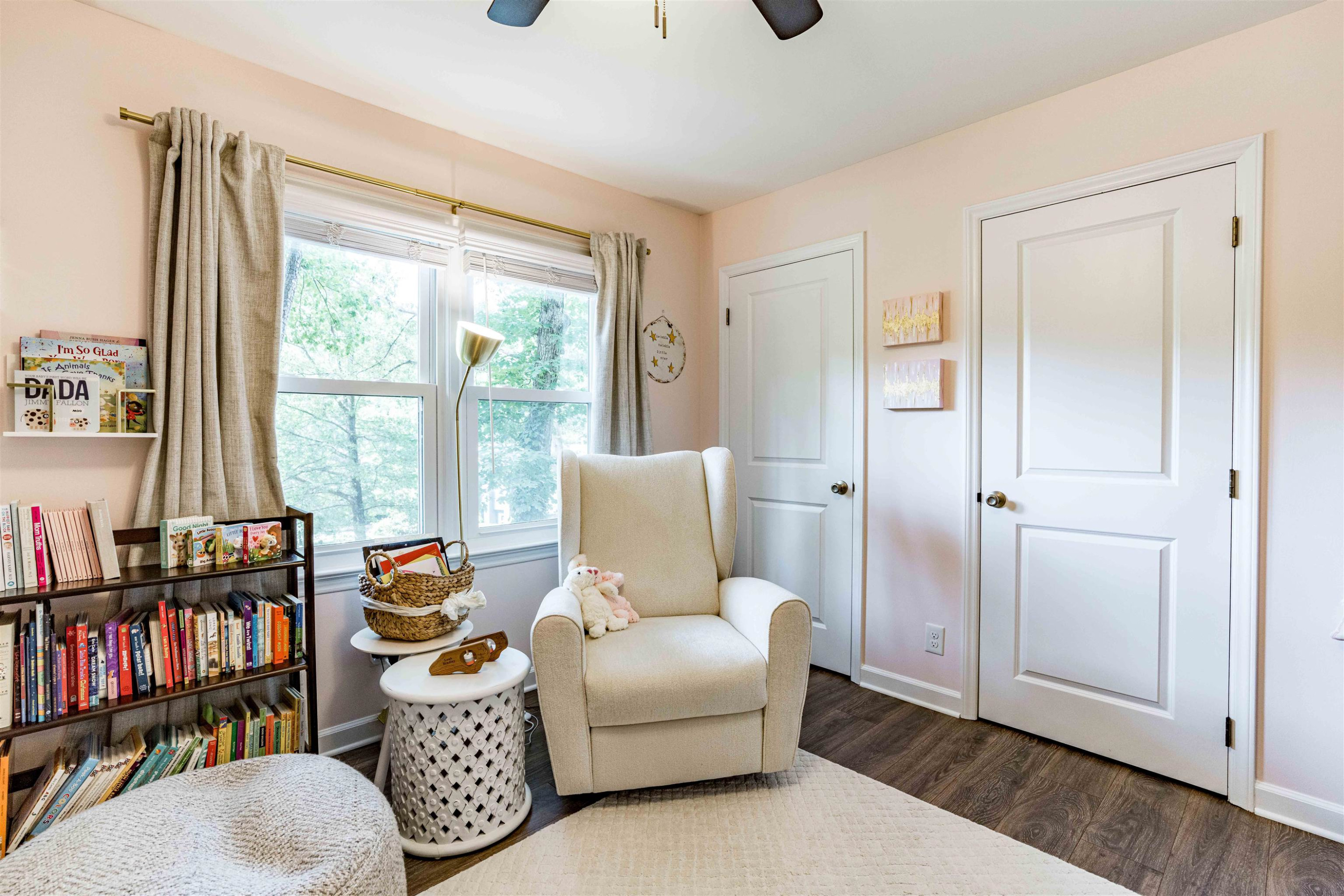 1505 Windbur Place Raleigh, NC 27609 - Photo 25 of 44 a living room with furniture a bookshelf and a window
