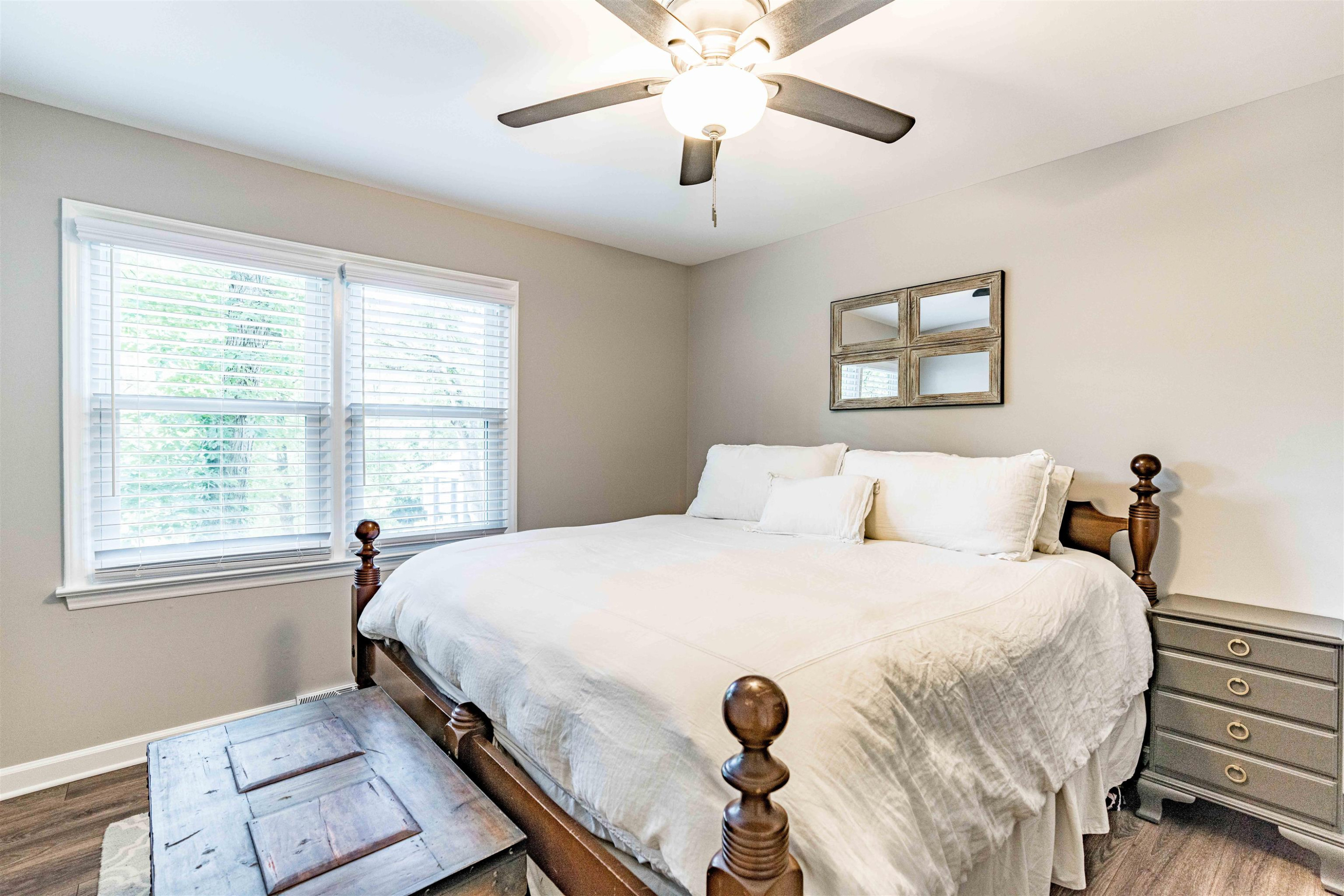 1505 Windbur Place Raleigh, NC 27609 - Photo 28 of 44 a bedroom with a bed and a chandelier