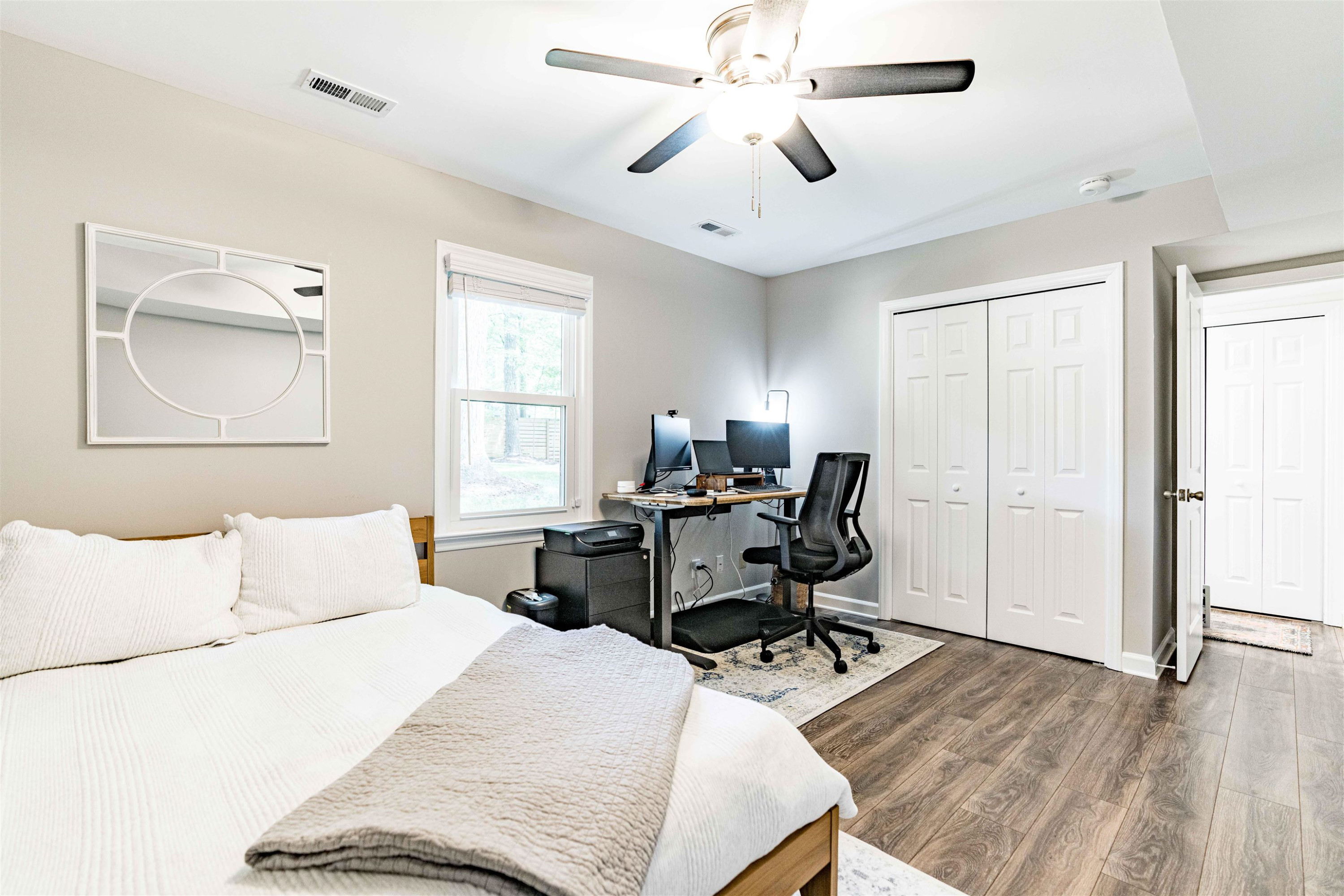 1505 Windbur Place Raleigh, NC 27609 - Photo 35 of 44 a bedroom with a bed and a chandelier