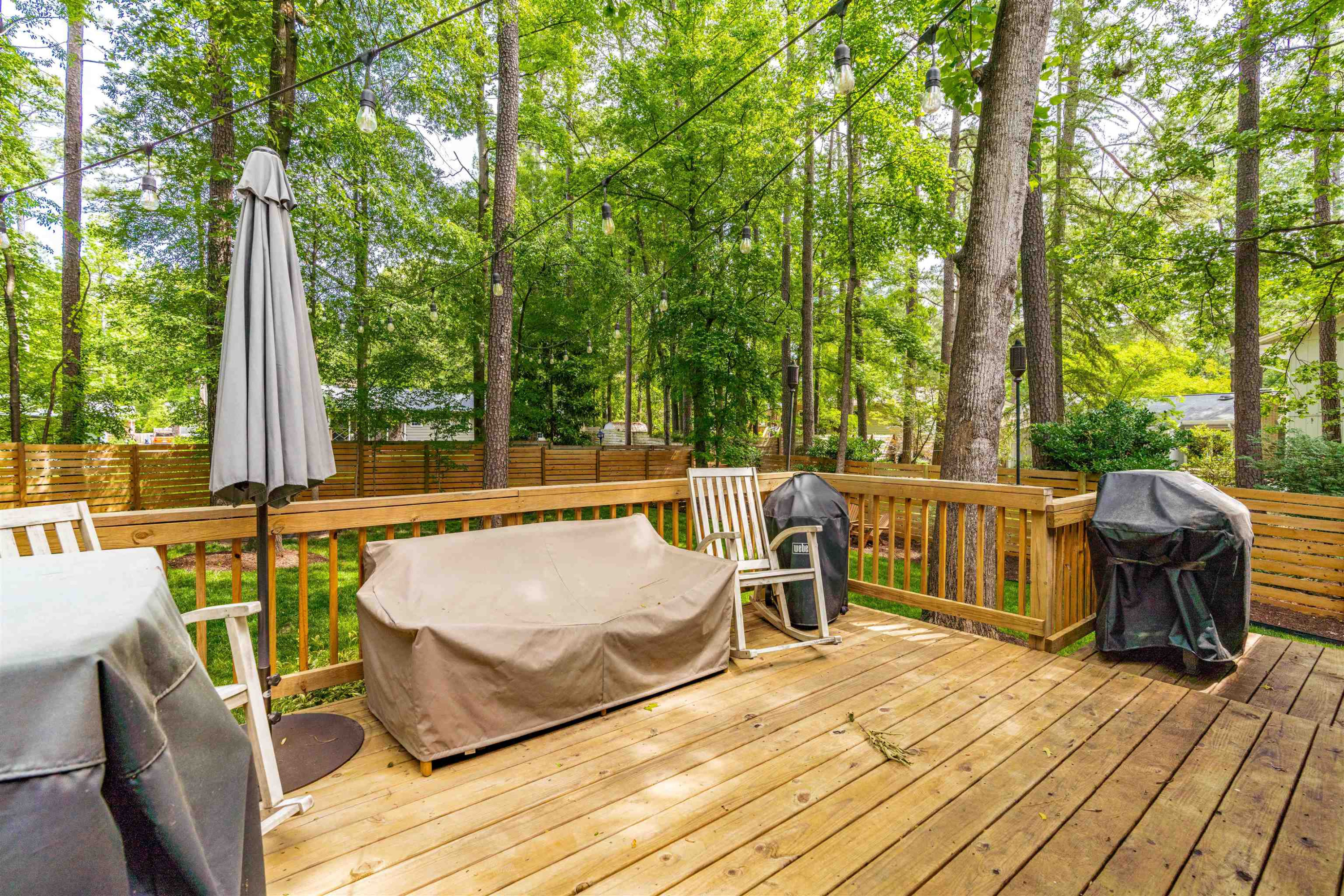 1505 Windbur Place Raleigh, NC 27609 - Photo 39 of 44 a roof deck with couches and wooden fence