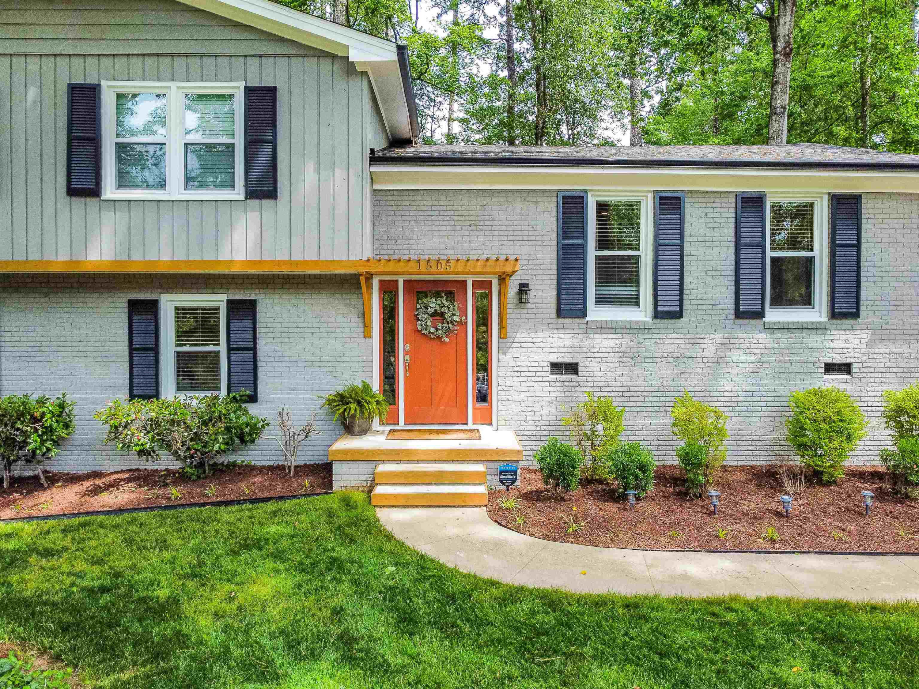 1505 Windbur Place Raleigh, NC 27609 - Photo 4 of 44 a front view of a house with garden