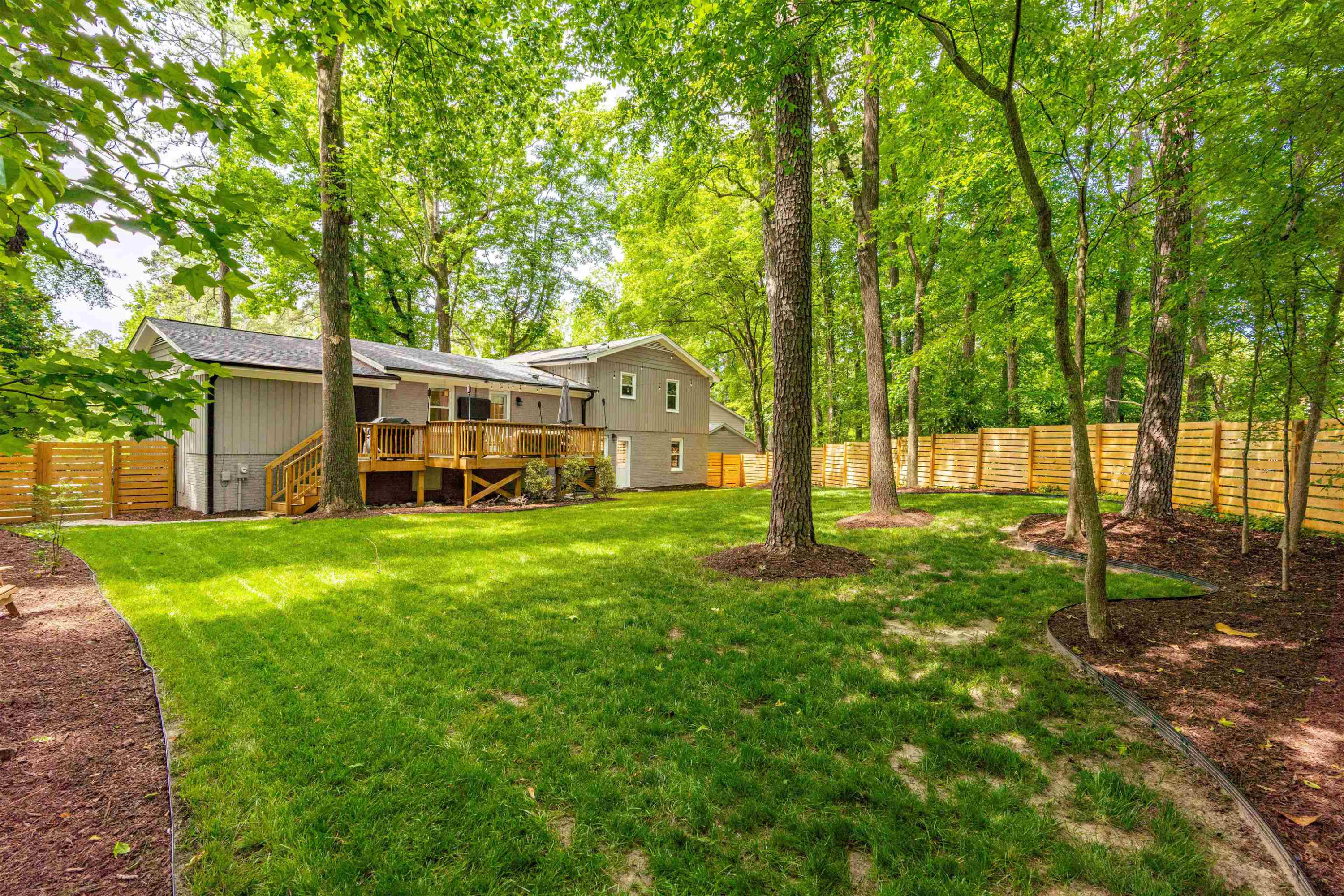 1505 Windbur Place Raleigh, NC 27609 - Photo 44 of 44 a view of a house with backyard and a tree