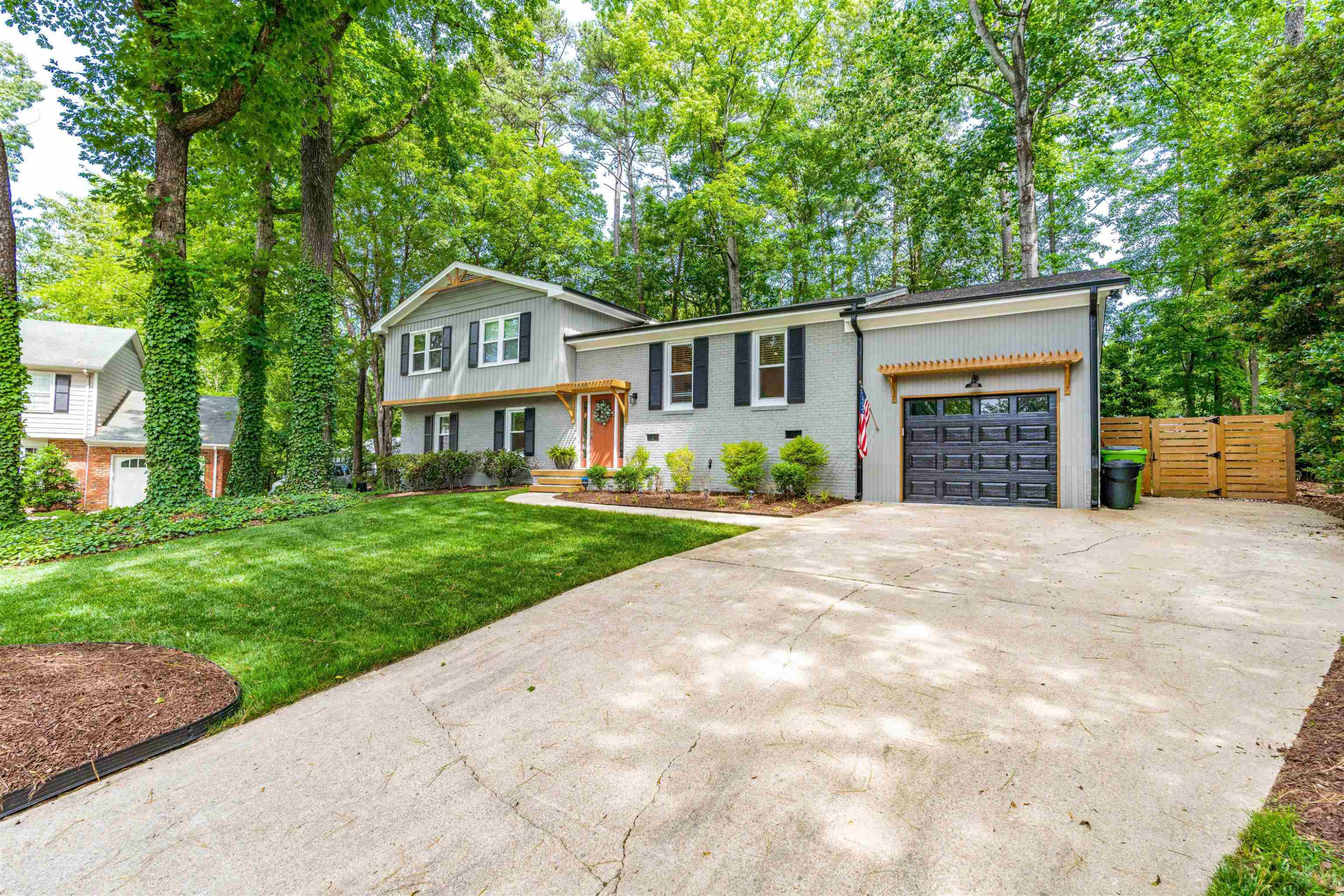 1505 Windbur Place Raleigh, NC 27609 - Photo 6 of 44 a front view of a house with a yard and garage