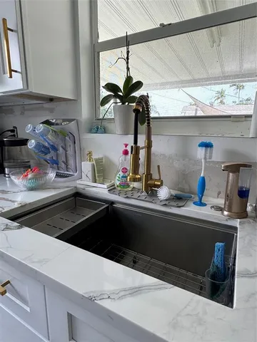 a kitchen with a sink and cabinets