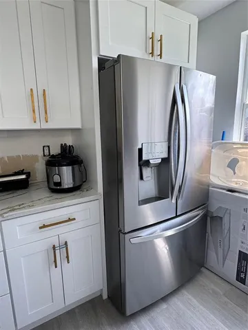 a kitchen with stainless steel appliances a refrigerator sink and cabinets